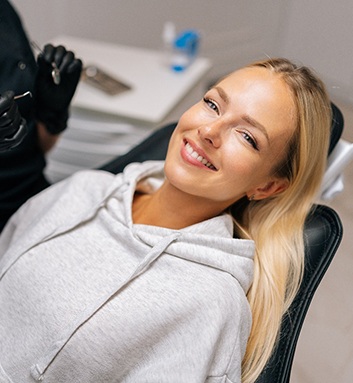 Patient reclined in treatment chair smiling