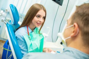 Young woman speaking with dentist